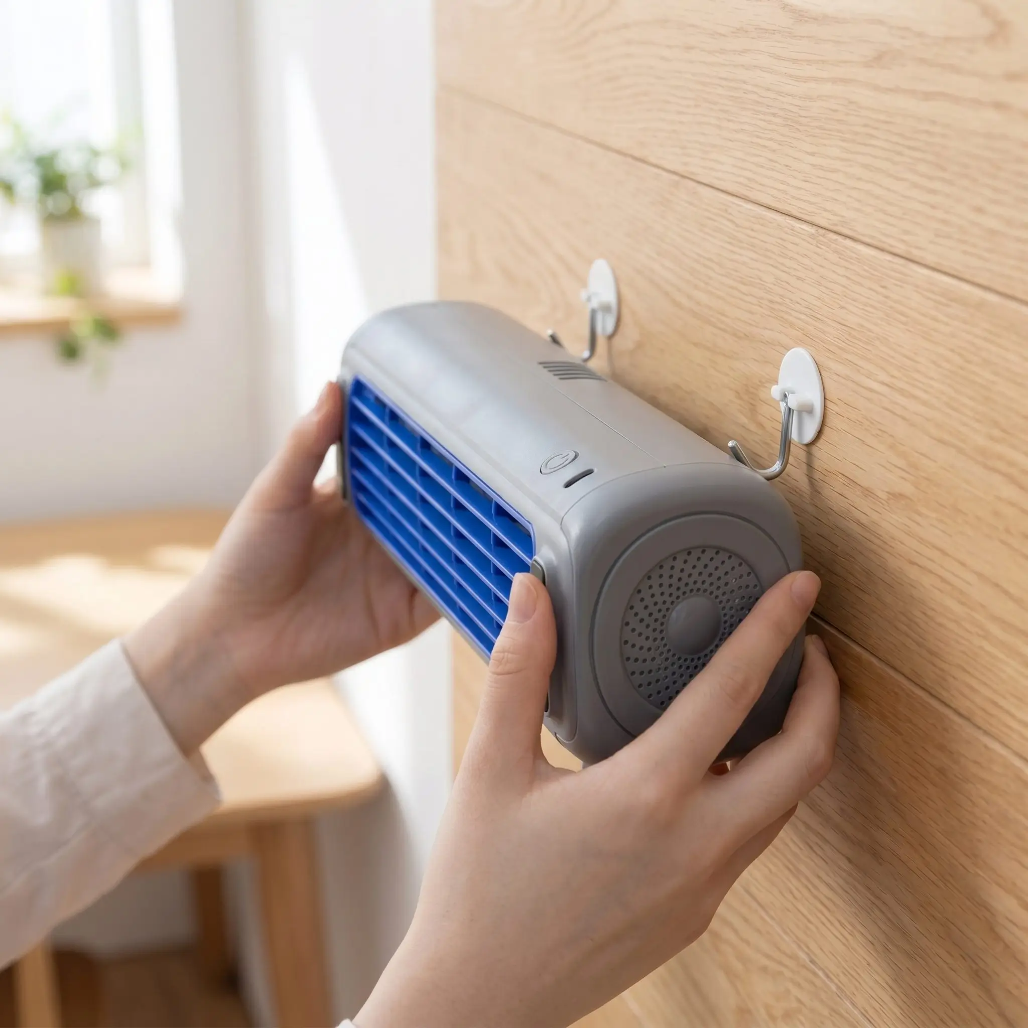 Froza Portable AC being placed on wall hooks